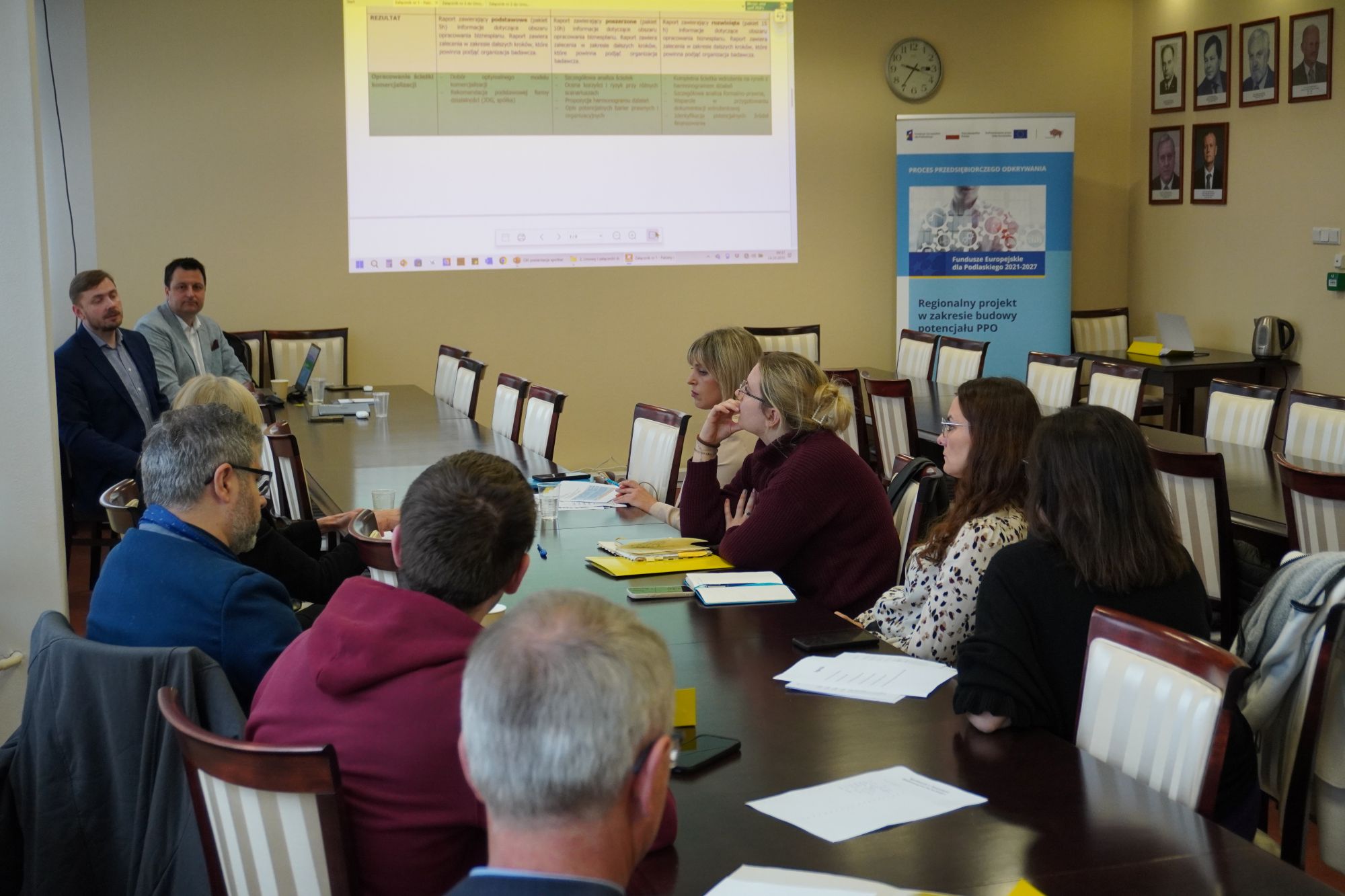 Uczestnicy spotkania siedzą przy stole